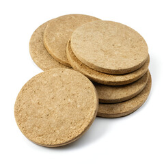 A group of round natural cork coasters stacked together isolated on a white background, offering surface protection