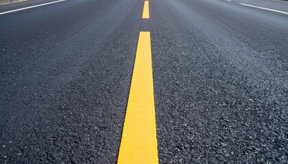 Close Up View Of Dark Asphalt Road With Yellow Center Line