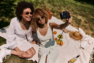 Joyful summer picnic moments captured between best friends in a sunlit park