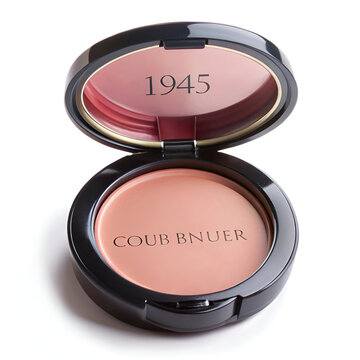 An open compact case of 1945 coub bnuer powder makeup with a mirror, isolated on white background