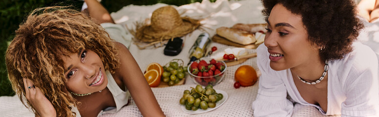 Summer picnic gathering of best friends in a lush park setting with delightful treats