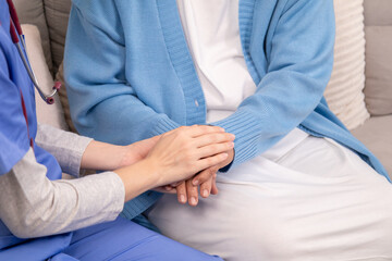 Obraz premium Caregiver in clinic consultation support, compassionate Nurse handhold senior patient at home shows trust communication, aging wellness journey, gentle touch reassures emotion, anxiety recovery