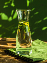 Artistic Photo of Mineral Water in Transparent Tumbler with Natural Light and Dreamy Green Background