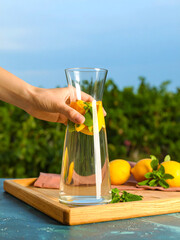 Artistic Photo of Mineral Water in Transparent Tumbler with Natural Light and Dreamy Green Background