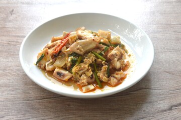 stir-fried spicy squid with salty egg and sauce on dish