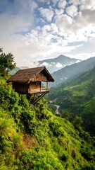 Wooden hut perched on mountainside, lush valley below
