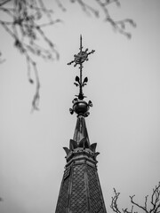 Architectural Beauty of Ornate Steeple Against Overcast Sky with Gothic Intricate Design