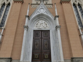 Artistic door on San Giovanni Battista church in Brembilla, Lombardy, Italy