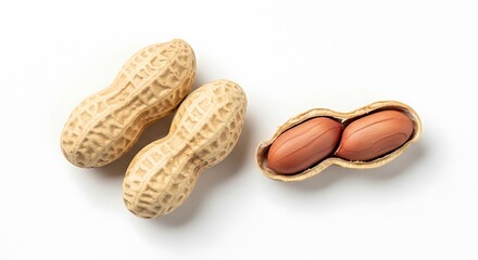 Two whole peanuts and one opened peanut shell with two kernels
