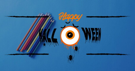 Showing Halloween graphic on blue backdrop, colored pencils and orange eyeball, bats and spiders