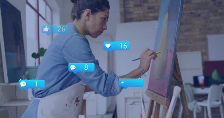 Painting artist wearing apron painting abstract circle on canvas in studio, with alerts, copy space