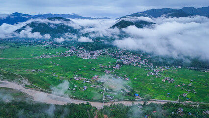 Lush green hills of Nepal blanketed in mist, showcasing the natural beauty and diverse landscape of...