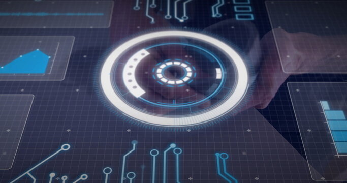 Adjusting technician hand touching holographic interface at control room, with circular control HUD