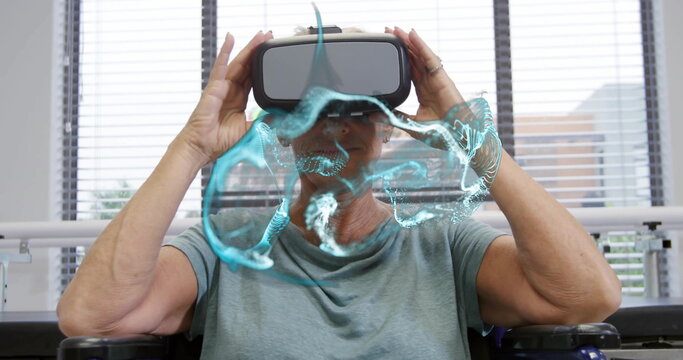 Senior woman wearing grey top adjusting VR headset in therapy room near blinds, projecting brain