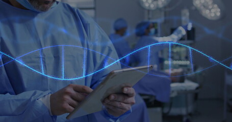 Holding tablet surgeon in blue scrubs examining holographic DNA in surgical suite, copy space