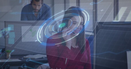 Agent wearing red blouse headset manipulating holographic overlay in open office with monitor