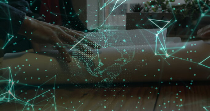 Unrolling blueprint with hands wearing shirt on office table near window, with holographic network - Powered by Adobe
