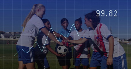 Gathering six soccer players huddling around soccer ball on soccer field, with jerseys and cleats