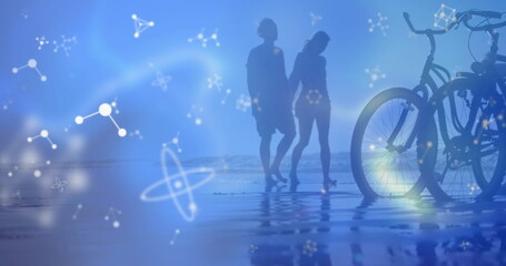 Fototapeta premium Walking silhouettes wearing shorts in shallow water at sandy beach, with bikes and network graphics