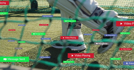 Stepping feet in gray sweats, white shoes moving on turf field near netting, with notifications