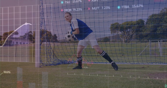 Crouching goalkeeper wearing gloves holding ball against goal net on pitch, with analytics overlays
