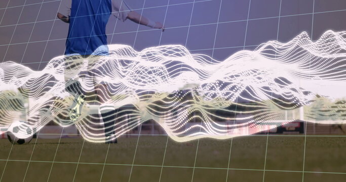 Kicking blue-vested soccer player sending soccer ball on grass field, with analytics overlay