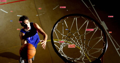 Leaping basketball player in blue jersey dunking ball at gym court, with overlay icons, copy space