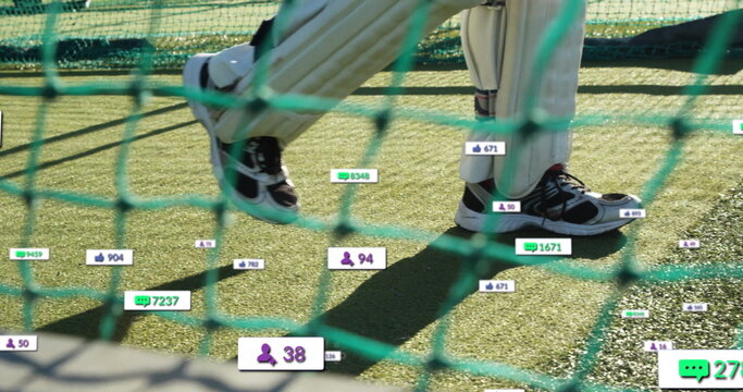 Capturing player wearing cricket pads and shoes standing on turf in net, with engagement icons