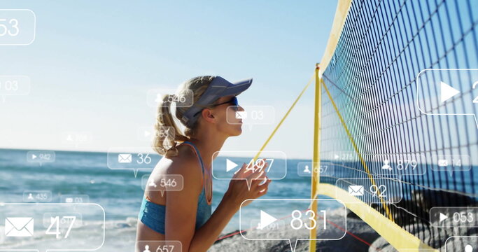 Kneeling athlete in sports-bra on beach facing yellow border volleyball net with icons, copy space