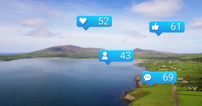 Hovering coastal bay stretching across fields and white houses, with social media icons - Powered by Adobe