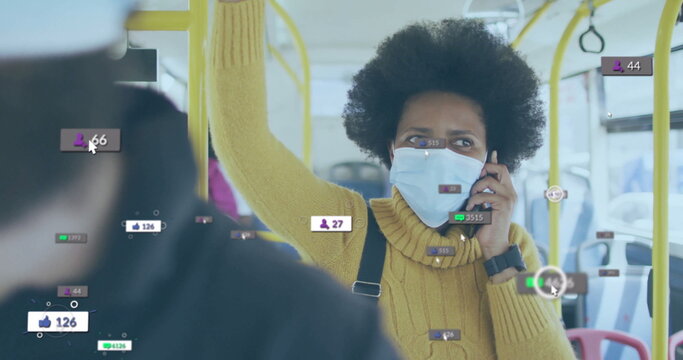 Talking commuter in yellow sweater wearing mask holding handrail on city bus, with smartphone - Powered by Adobe