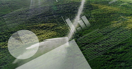 Spraying center-pivot sprinkler arm misting plume over fields in aerial view, with overlay graphics