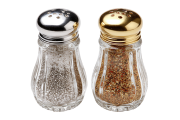 Two glass pepper and salt shakers, side-by-side, with metal lids. One shaker contains white salt, the other contains a blend of dark and light spices