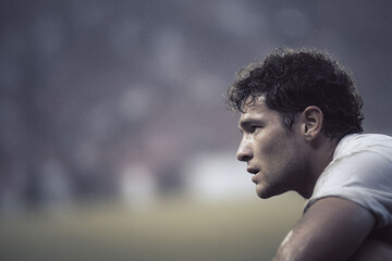 Intense, determined athlete in profile, drenched in sweat, focused on the game. Represents grit, perseverance, and the drive to succeed. Ideal for sports, fitness, and motivation.