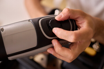 Hand Operating a Sleek and Modern Grooming Device Designed for Personal Care and Hair Styling