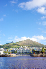 Beautiful waterfront view of Cape Town, South Africa, showcasing the iconic Signal Hill under a...