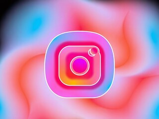 Instagram logo on a colorful gradient background with pink orange and blue hues design