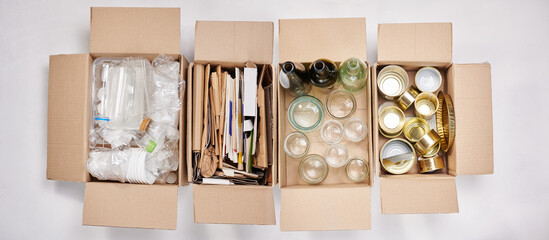 Sorting garbage for recycling. Four cardboard boxes with assorted garbage, plastic, paper, glass and tin Garbage separation concept, waste recycle, waste sorting.