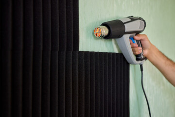 Applying Soundproof Foam Panels Securely Using a Hot Glue Gun for Better Performance and Insulation
