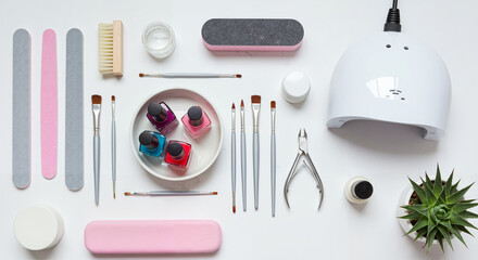 Nail care tools arranged on a white background with colorful polish  