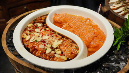 Fresh salmon and marinated salmon beautifully arranged on a plate make for a delicious and healthy meal.