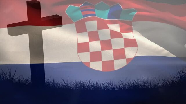 Wind starting Croatian flag waving past cross, billowing crest shifting honoring memorial