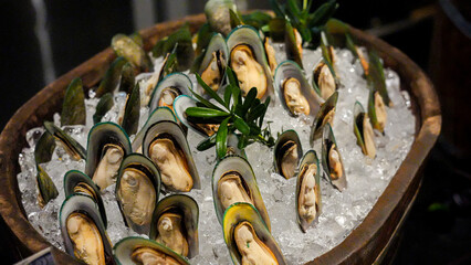 Close-up of seafood served in a hotel and beautifully arranged on wooden barrels.