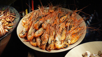 Delicious, fresh seafood dinner with grilled shrimp and roasted red sauce on a plate