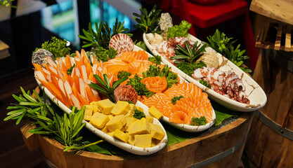 Gourmet salmon sushi rolls and a healthy salad meal on a restaurant table