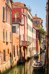 View of the unique and characteristic Venetian canals, where typical boats knew as Gondola are used for tourist sightseeing. Worldwide famous, Venezia is a unique kind of city and UNESCO site.