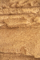 Sand stone wall ridged textured gritty yellow wet dry background