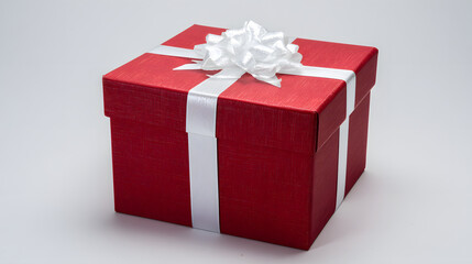 Obraz premium Red gift box with white ribbon and bow, centered product shot on clean background.