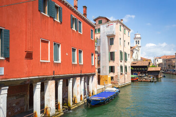 View of the unique and characteristic Venetian canals, where typical boats knew as Gondola are used for tourist sightseeing. Worldwide famous, Venezia is a unique kind of city and UNESCO site.