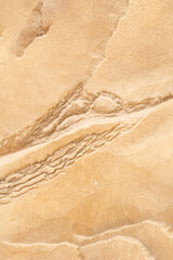 Sand stone wall ridged textured gritty yellow wet dry background